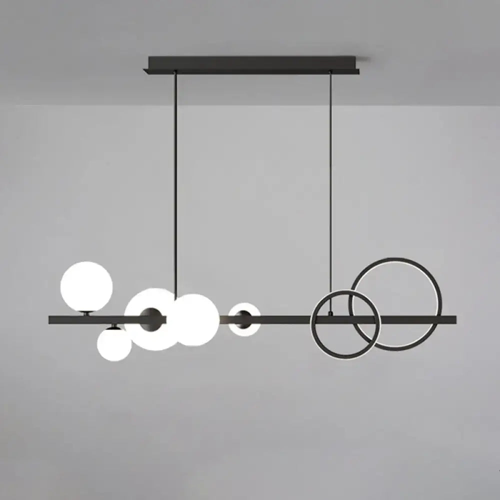 Modern black metal pendant light fixture with spherical glass shades for dining room ceiling light use