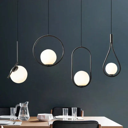 Modern black metal pendant light dining room fixture with frosted glass globe shades and geometric black metal ring design