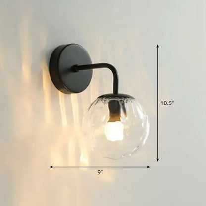 Modern black metal wall mount light with textured rippled glass globe ideal for bedroom sconce lighting