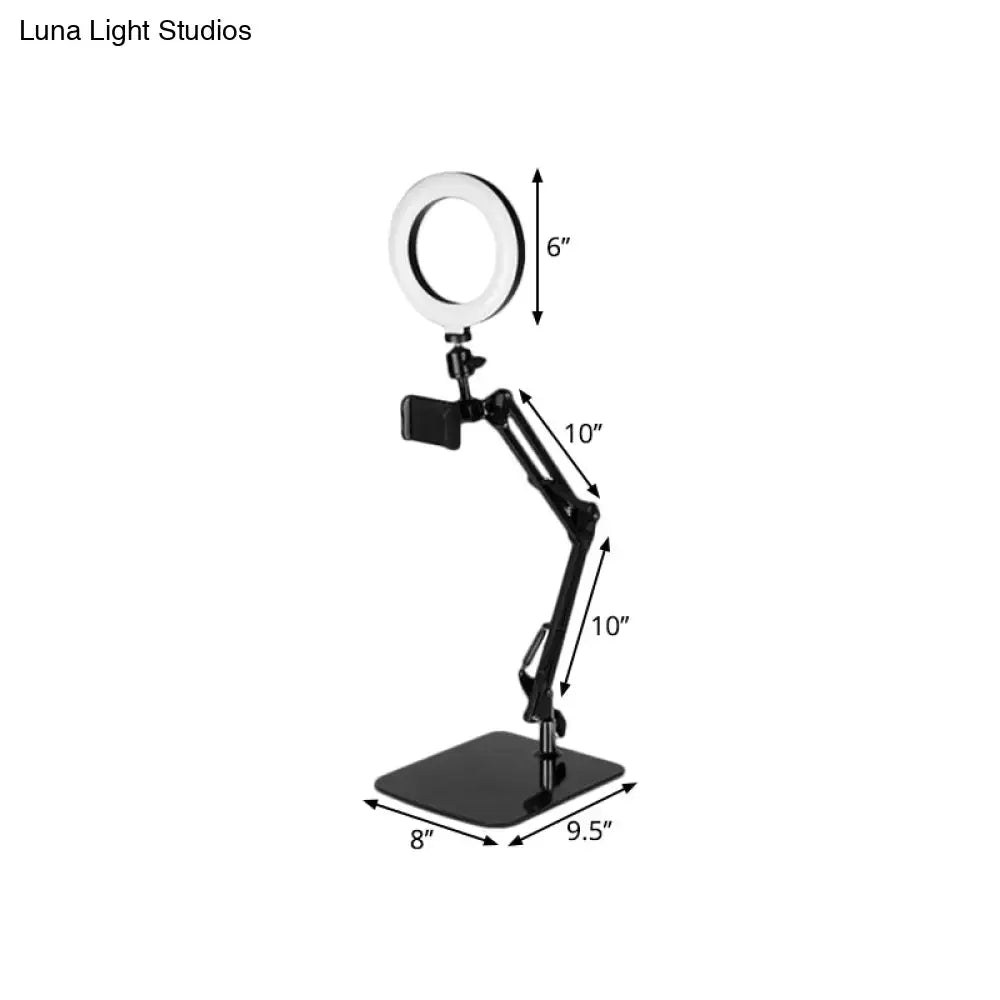 Modern black metal shade ring light with 6-inch LED ring and adjustable phone clamp on an adjustable ring light stand