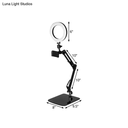 Modern black metal shade ring light with 6-inch LED ring and adjustable phone clamp on an adjustable ring light stand