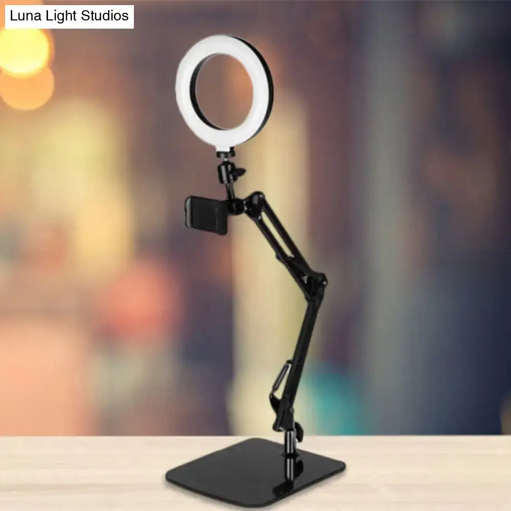 Modern black metal shade ring light with adjustable phone mount and sleek minimalist design for bedroom use