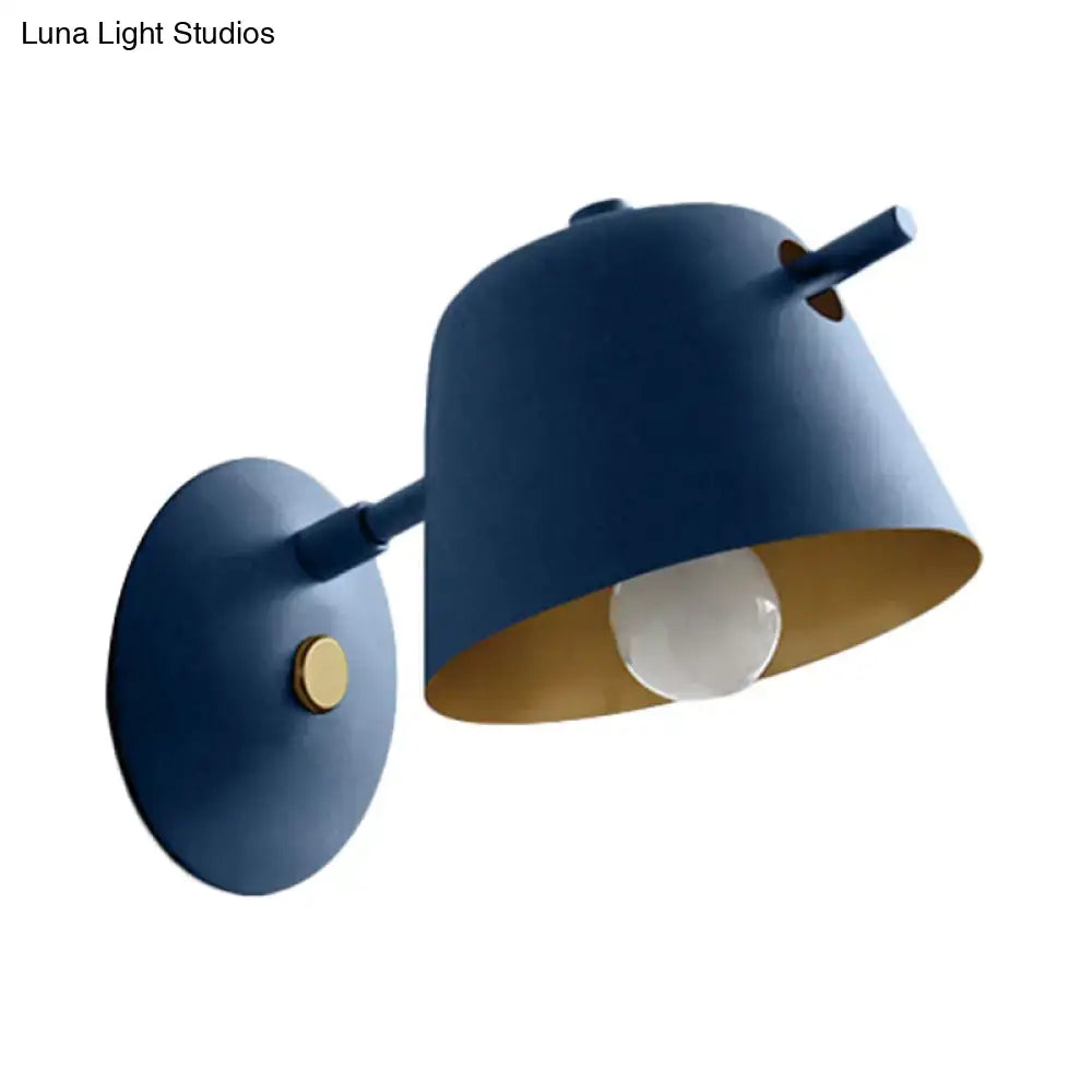 Modern black metal shade wall sconce with a blue wall-mounted lamp featuring a matte finish and gold interior for bedroom lighting