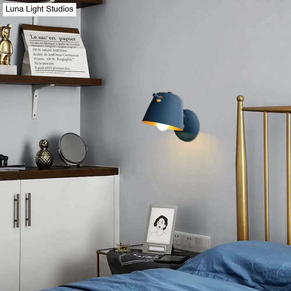 Modern metal shade wall sconce with blue matte finish and warm-toned interior for white blue bedroom lighting