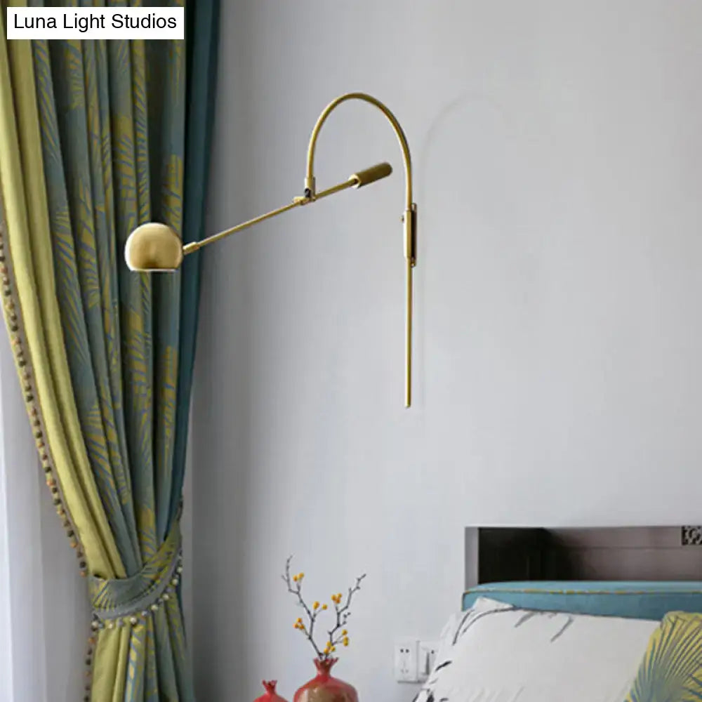 Modern black metal sphere wall sconce with curved arm and gold-toned direct wired electric reading lamp head