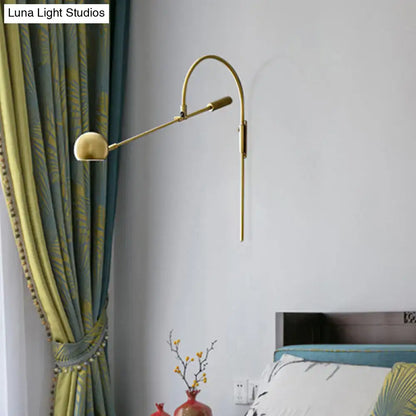 Modern black metal sphere wall sconce with curved arm and gold-toned direct wired electric reading lamp head