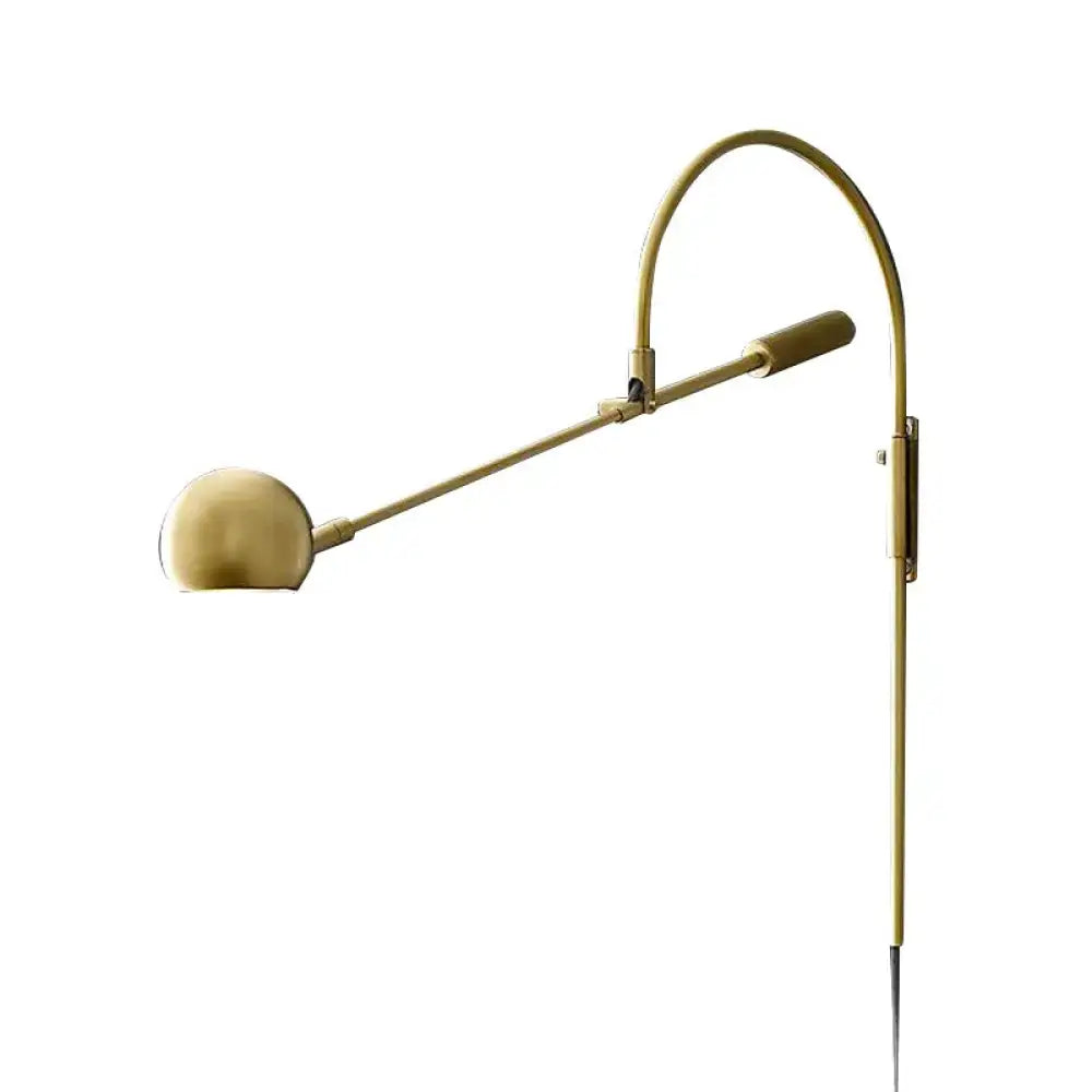 Modern black metal sphere wall sconce with curved arm and brass finish direct wired electric bedroom light