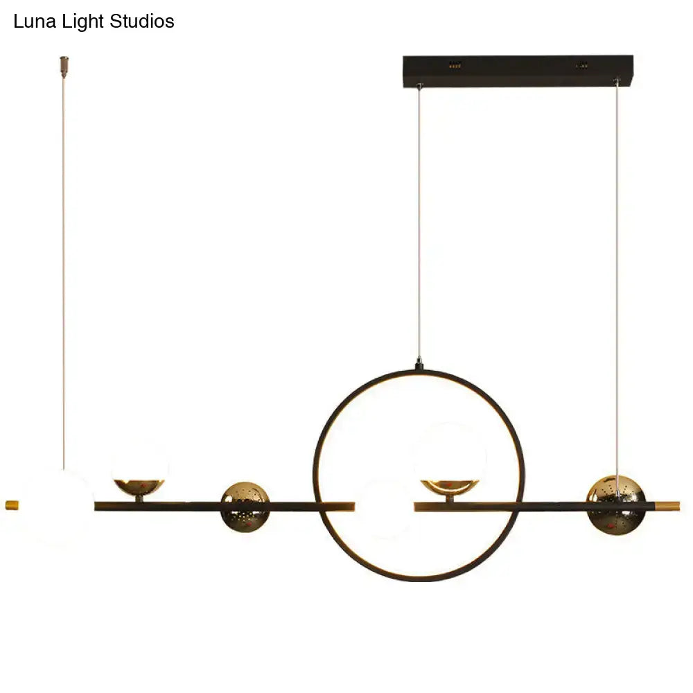Modern black metal spherical glass pendant light with geometric gold accents for dining room lighting