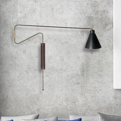 Modern black metal wall lamp featuring a conical shade, slender articulated arm, and black gold brass accents for living room