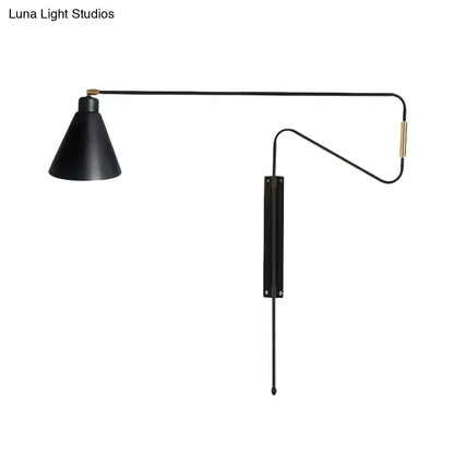 Modern black metal wall lamp with long articulated arm, black matte finish, and brass accents for living room use