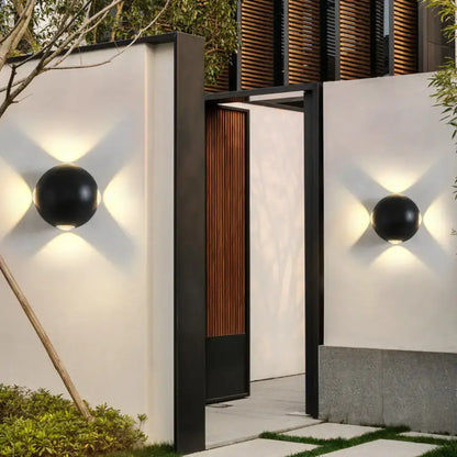 Modern black metal wall light direct wired electric spherical sconces with matte finish mounted on entryway sides