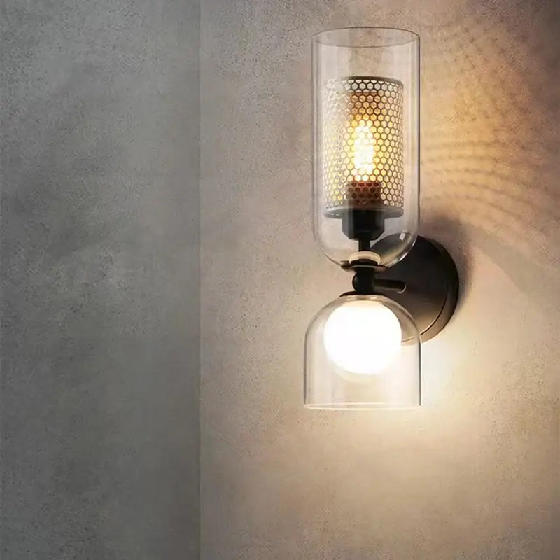 Modern black metal wall light with clear glass cylinder and perforated shade for bedroom sconce decorbites clear glass