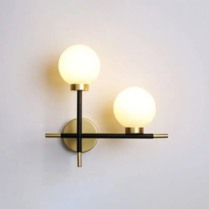 Modern black milk glass wall mount light fixture with matte black and brass two-light sconce for foyer lighting