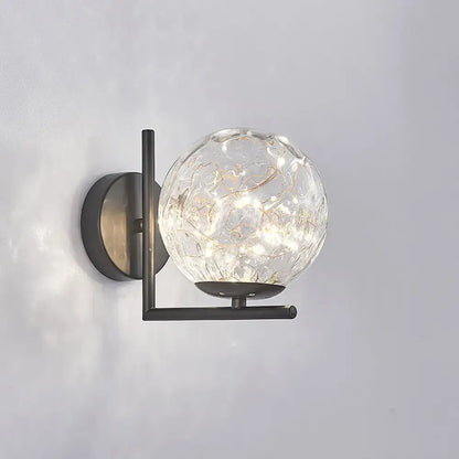 Modern black mini globe wall sconce with textured clear glass and delicate led lights on a sleek metal frame fixture height