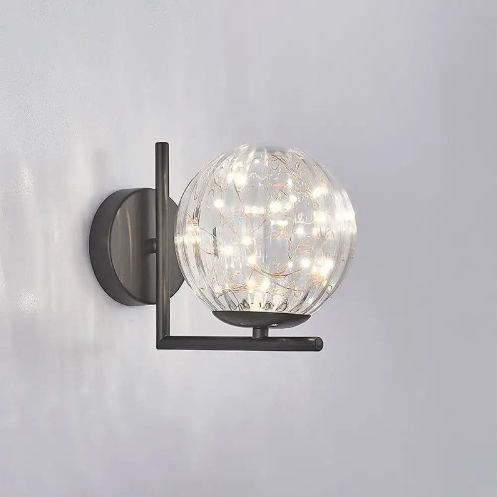 Modern black mini globe wall sconce with clear textured glass globe and warm LED fairy lights fixture height ideal for bedrooms
