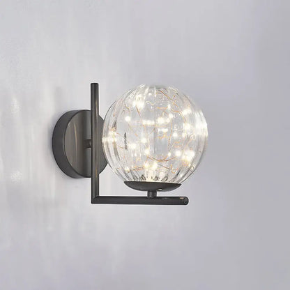 Modern black mini globe wall sconce with clear textured glass globe and warm LED fairy lights fixture height ideal for bedrooms