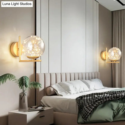 Modern black mini globe wall sconce with gold-toned fixture height and spherical glass globe housing warm led lights