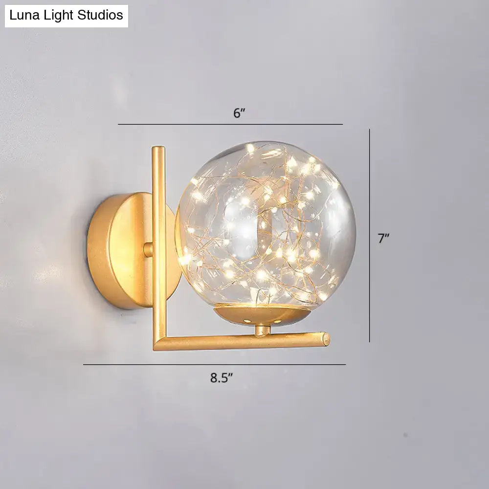 Gold-finished wall sconce mini globe fixture with clear glass globe and fairy lights ideal for modern bedroom decor fixture height included