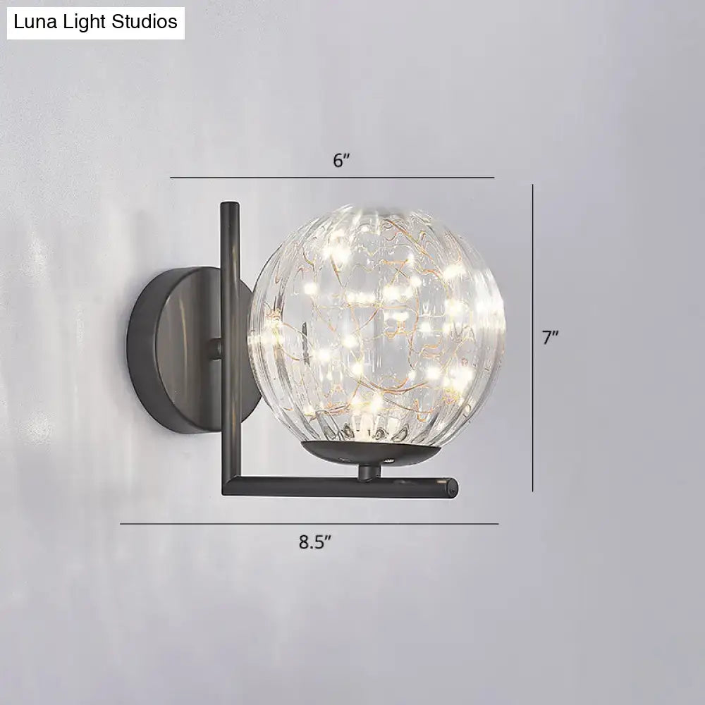 Modern black mini globe wall sconce with clear glass globe and delicate string lights fixture height ideal for bedrooms
