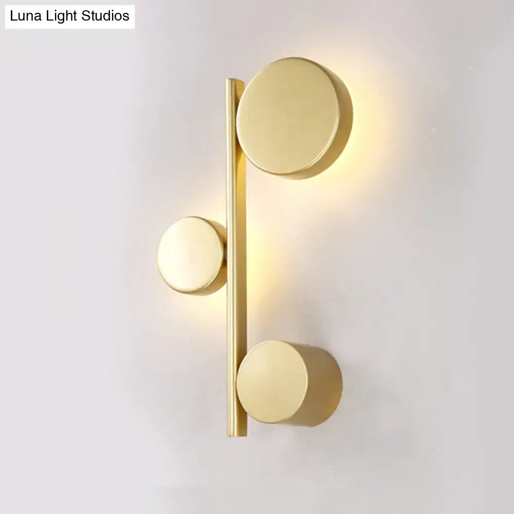 Modern gold-finished circle wall mount sconce with three circular lights for minimalist living room decor