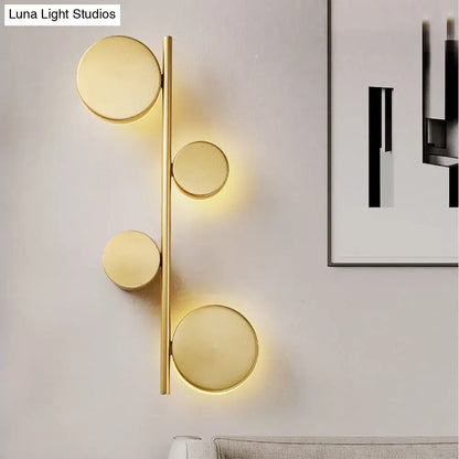 Modern gold-toned circle wall mount led sconce with four circular lights for living room lighting