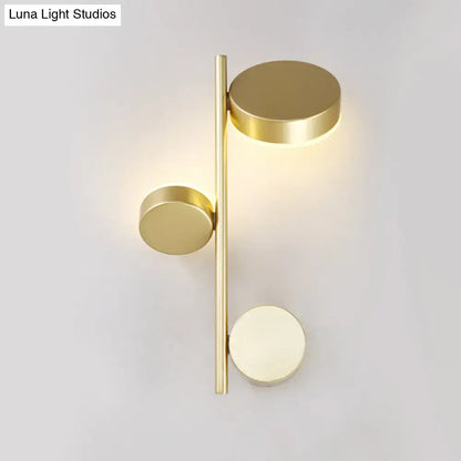 Modern gold-toned circle wall mount led sconce with three discs on a slender bar for living room decor
