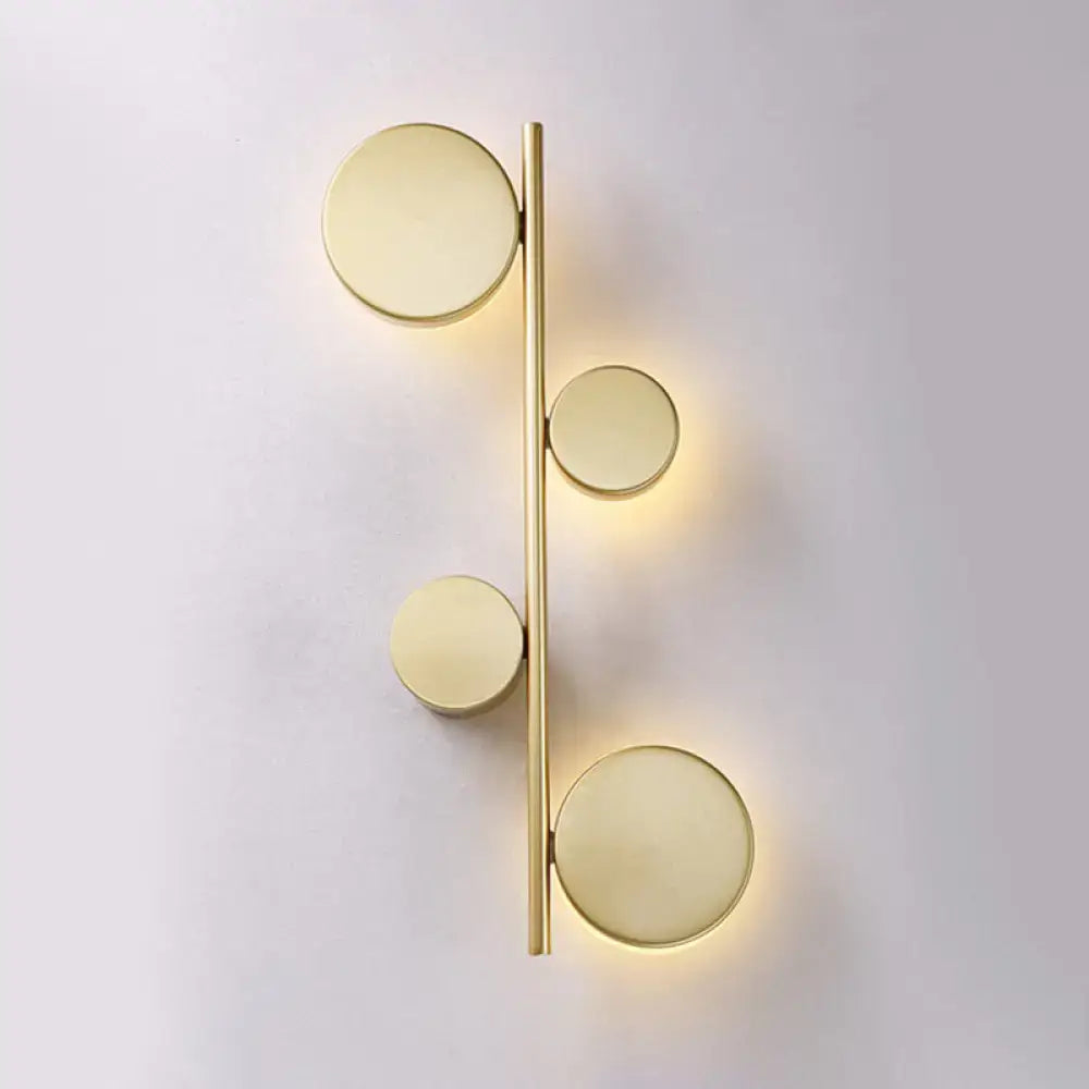 Modern gold-toned circle wall mount led sconce with four glowing fixtures for living room minimalist decor