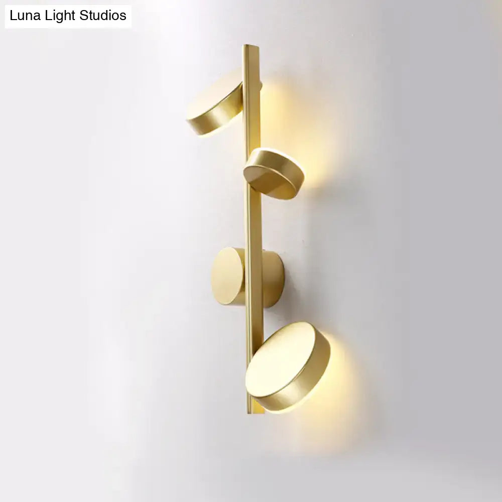 Modern gold-toned circle wall mount LED sconce with four illuminated fixtures for minimalist living room decor