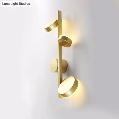 Modern gold-toned circle wall mount LED sconce with four illuminated fixtures for minimalist living room decor