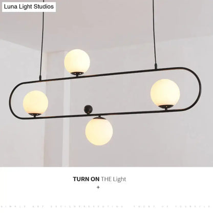 Modern black minimalist ellipse ceiling light with black metal frame and four frosted glass globes for living room