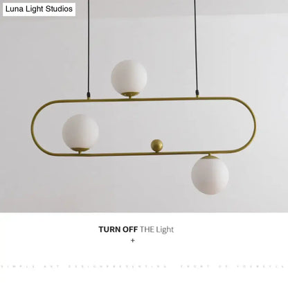 Gold-toned oval chandelier ceiling light with white glass globes and a minimalist ellipse design for living room use