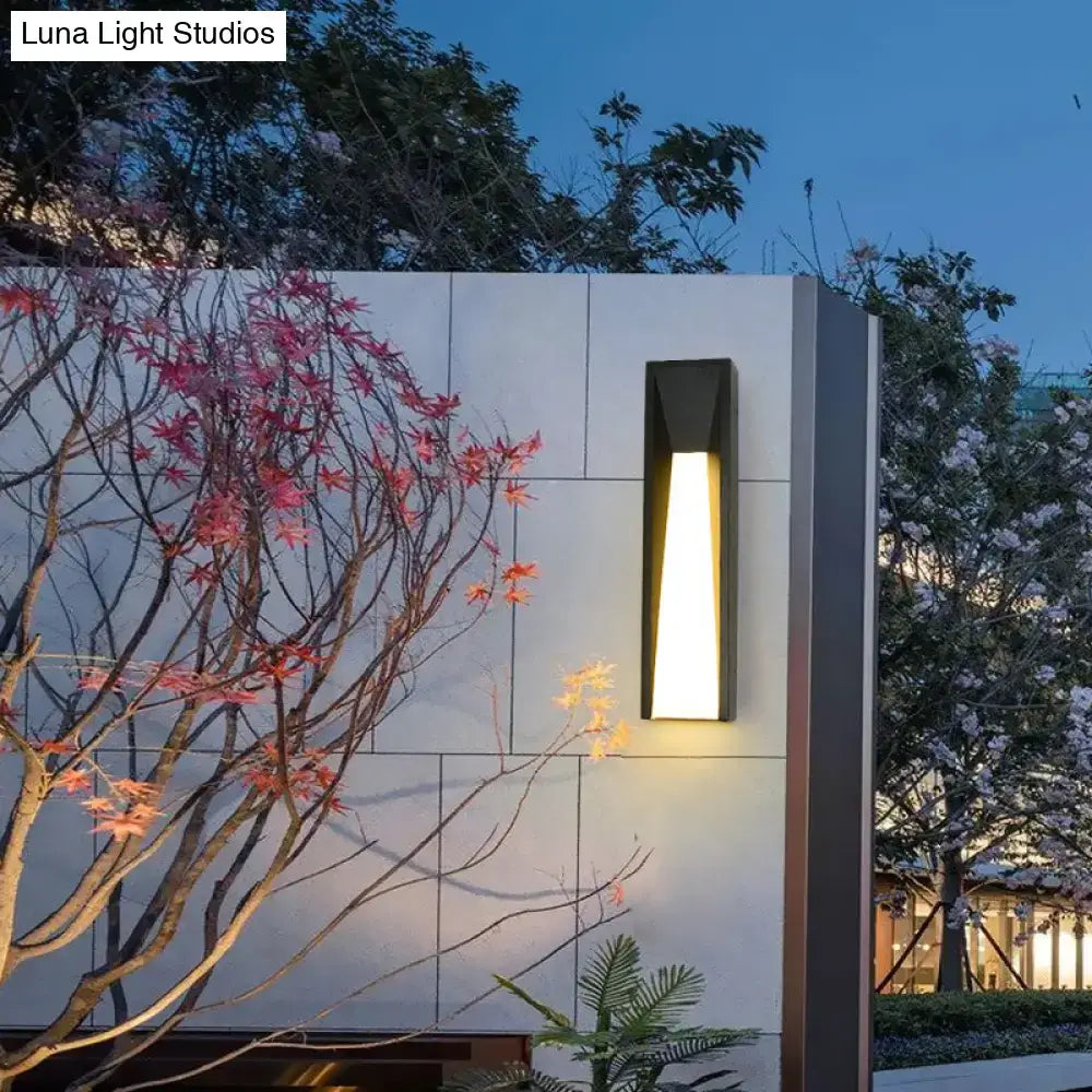 Modern black minimalist led wall light with warm glowing light designed as a rectangular courtyard sconce