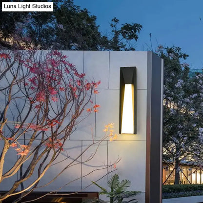 Modern black minimalist led wall light with warm glowing light designed as a rectangular courtyard sconce