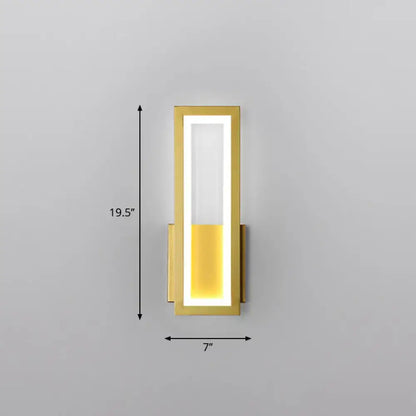 Modern black minimalist wall sconce with gold frame and glowing white amber led light panel for foyer lighting