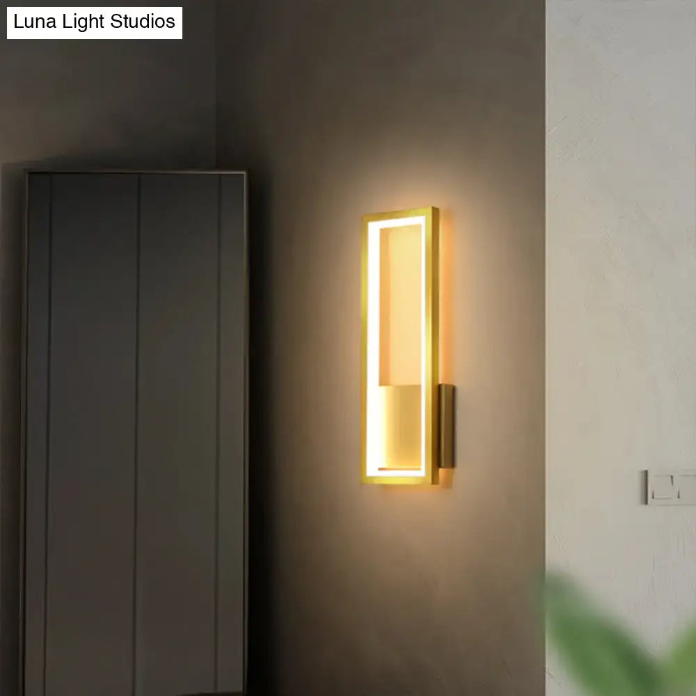 Modern black minimalist LED wall sconce with a gold frame and warm light for foyer rectangular lighting