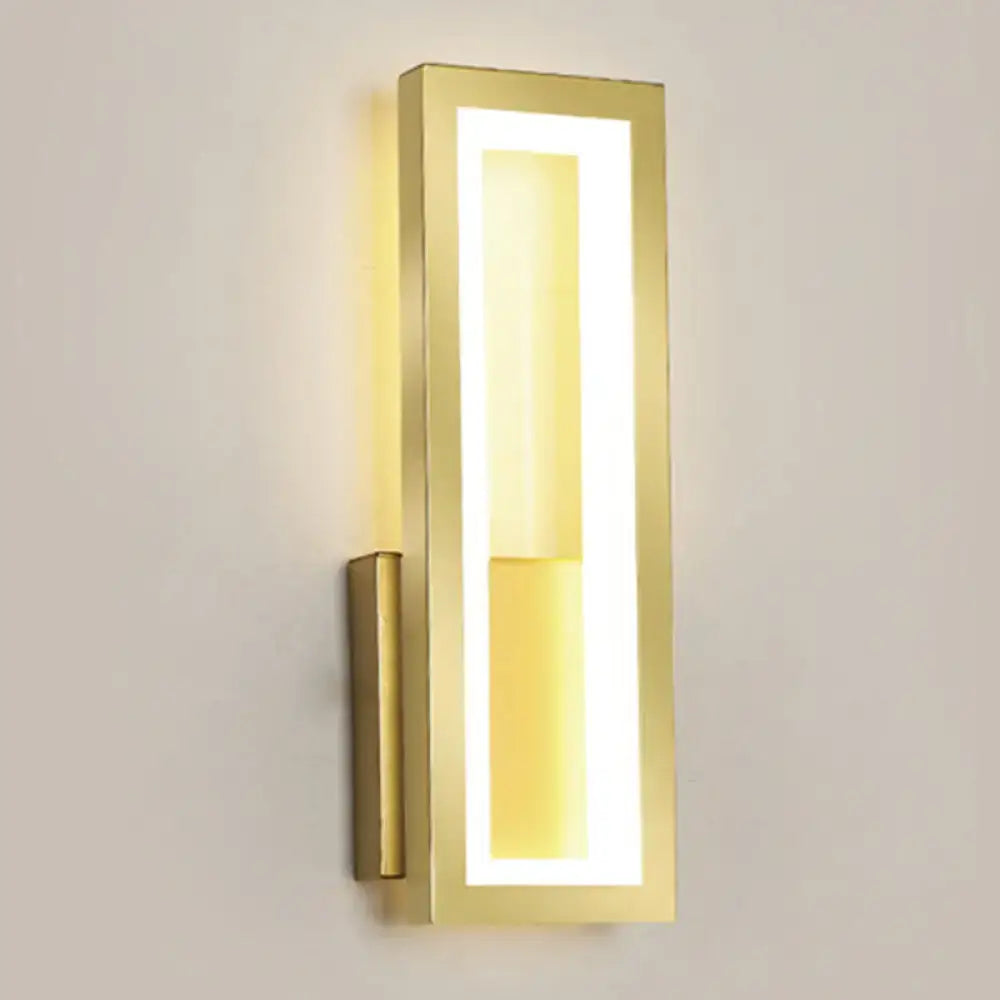 Gold-finished rectangular led wall sconce with acrylic shade and warm bedside lighting in a sleek modern design