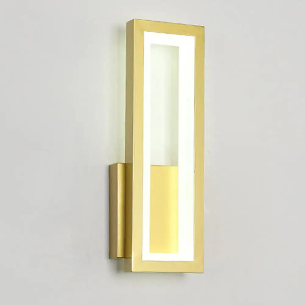 Gold-finished rectangular wall sconce with acrylic shade and warm bedside lighting in sleek modern design