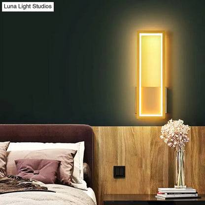 Modern black minimalist led wall sconce with acrylic shade and warm bedside lighting in a sleek metallic frame