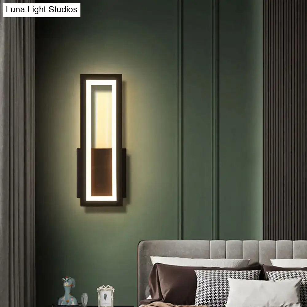 Modern black minimalist led wall sconce with acrylic shade and warm bedside lighting in sleek rectangular frame