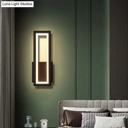 Modern black minimalist led wall sconce with acrylic shade and warm bedside lighting in sleek rectangular frame