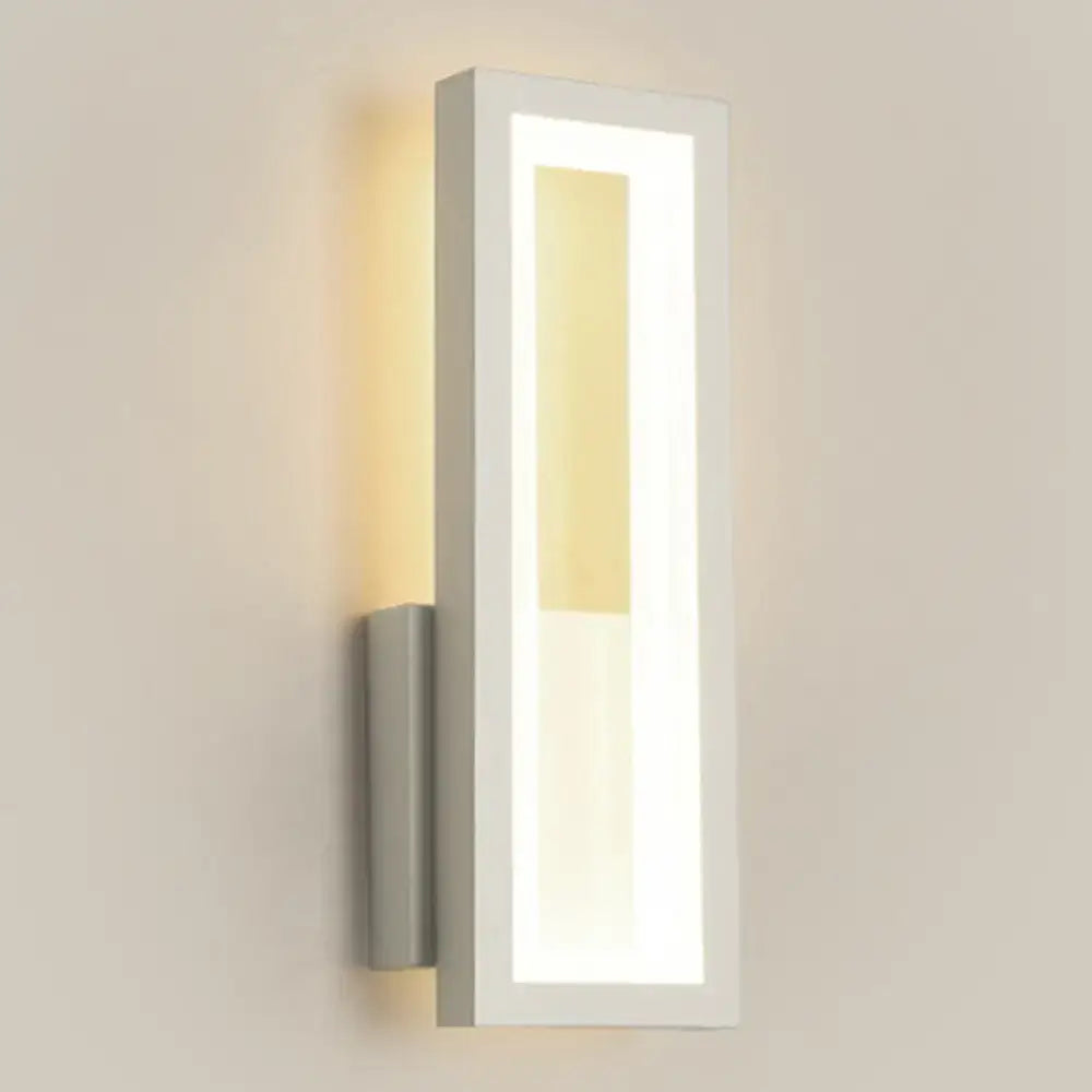 Modern black minimalist led wall sconce with acrylic shade and warm bedside lighting in a sleek rectangular design