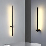 Modern black minimalist rotatable led wall light with sleek vertical rod and warm ambient illumination for bedroom