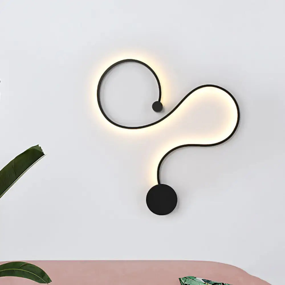 Modern black minimalist wall lamp with sleek curved design and soft white light for living room illumination