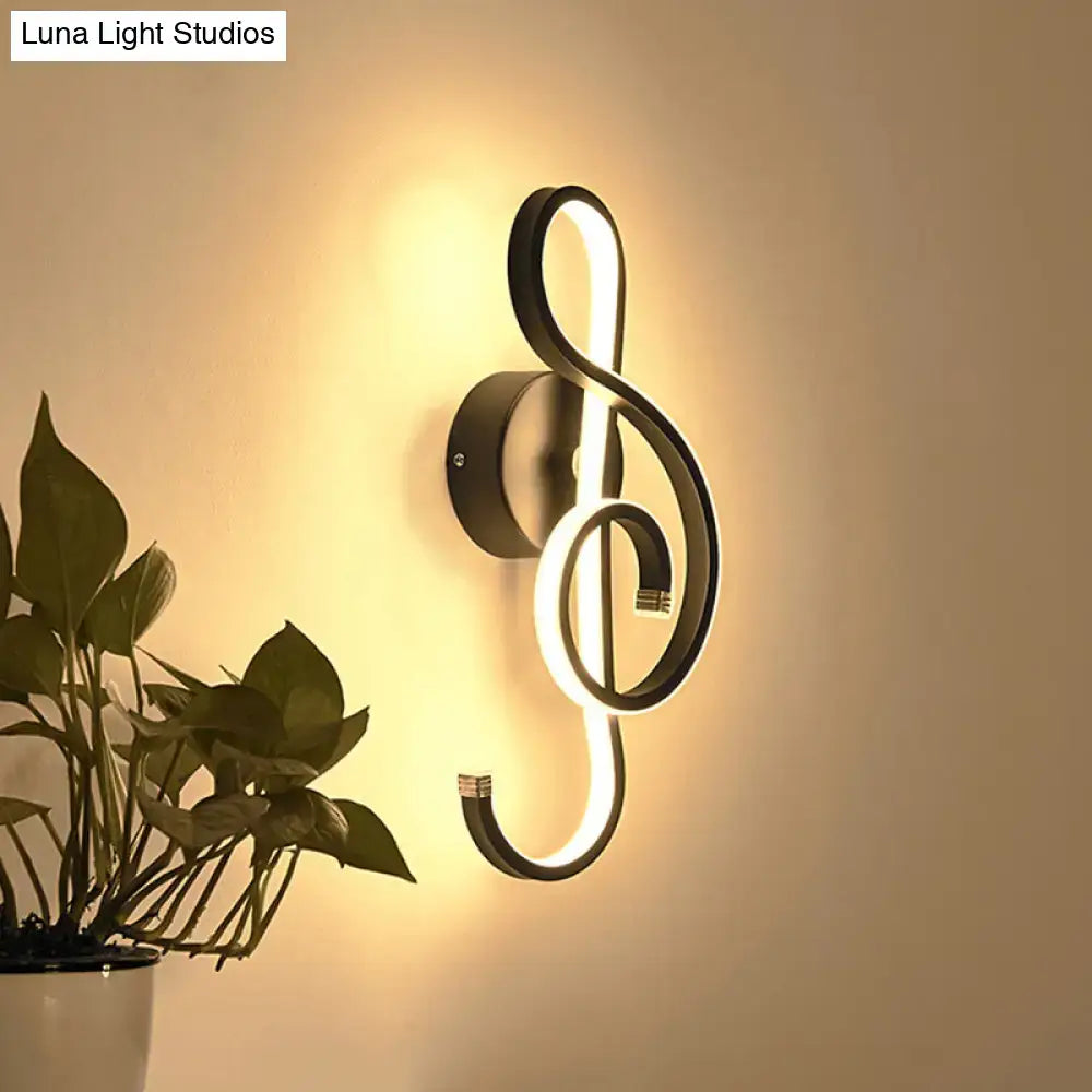 Modern black led wall lamp in music note design emitting warm ambient light for living room wall light