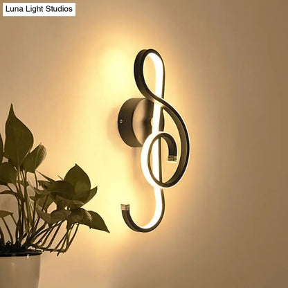 Modern black led wall lamp in music note design emitting warm ambient light for living room wall light