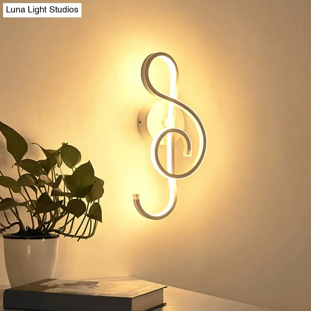 Modern black wall light with music note design featuring an illuminated led treble clef and minimalist metallic finish