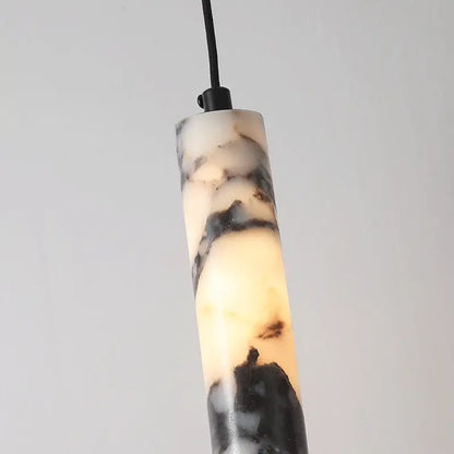 Modern black natural marble stone cylinder pendant light with polished swirling black and cream veining for kitchen