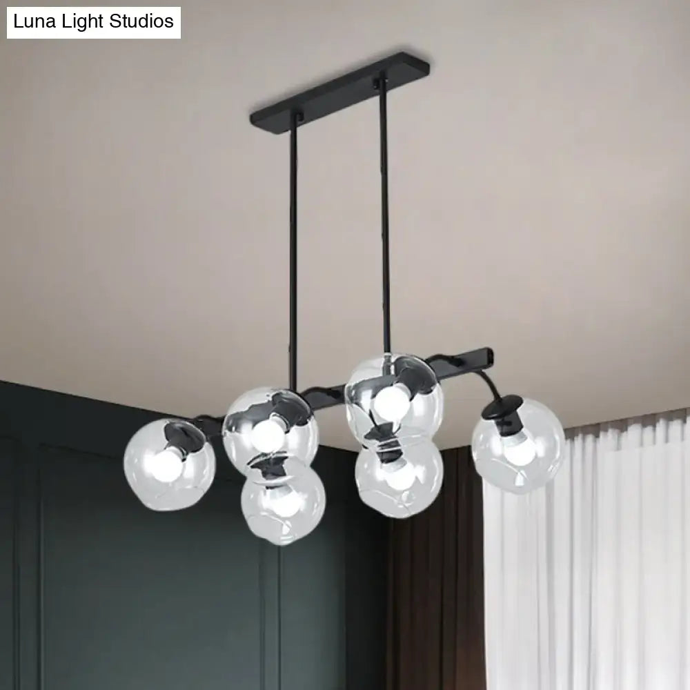 Modern black metal chandelier with five clear glass globe bulbs featuring a black orb shade for kitchen and dining room