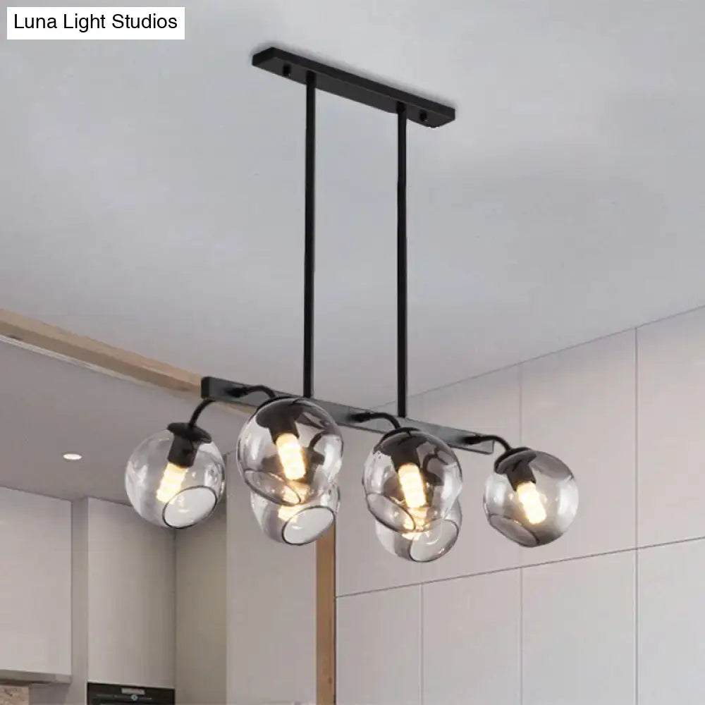 Modern black metal chandelier with four clear glass globe shades and black orb shade for kitchen and dining room lighting