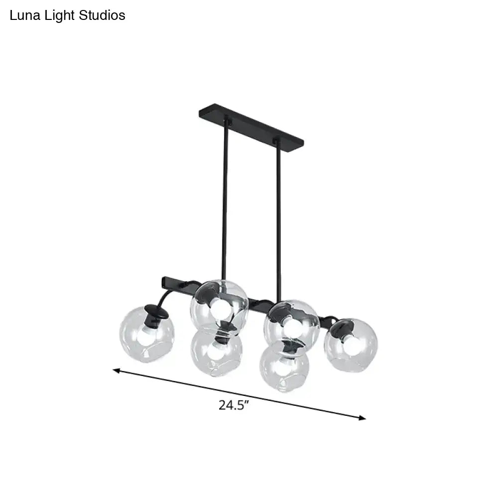 Black metal chandelier with five clear glass globe shades featuring a modern orb shade for kitchen and dining room use